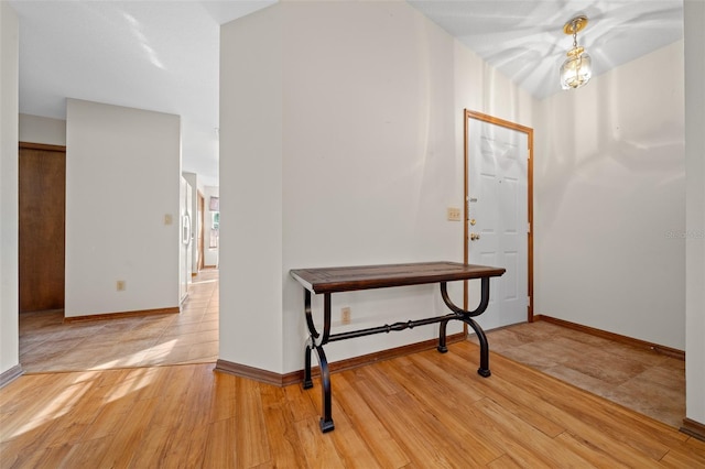 hallway with light hardwood / wood-style flooring