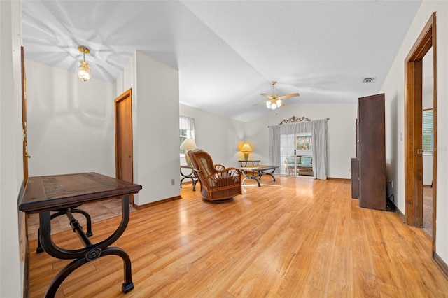 sitting room featuring ceiling fan, lofted ceiling, and light hardwood / wood-style floors