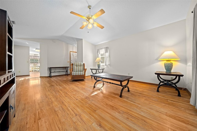 sitting room featuring ceiling fan, light hardwood / wood-style flooring, and lofted ceiling