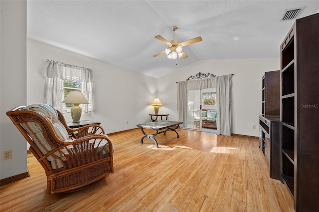 sitting room featuring ceiling fan, vaulted ceiling, and light hardwood / wood-style flooring