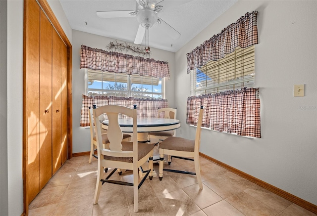 tiled dining area featuring ceiling fan