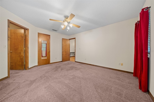 unfurnished bedroom featuring light carpet and ceiling fan