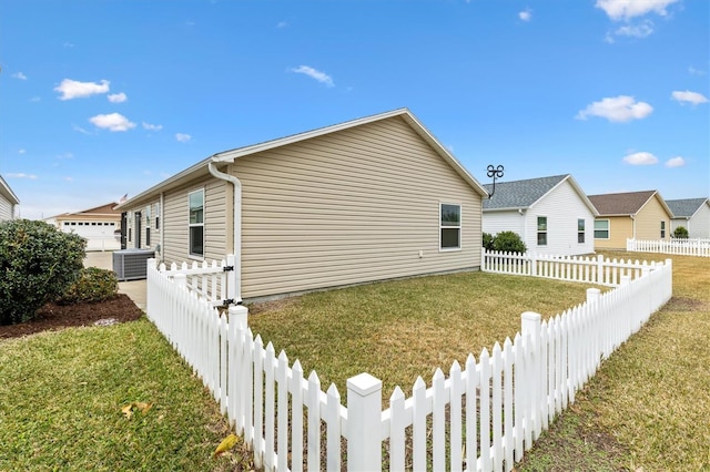 view of side of home with a garage and a lawn