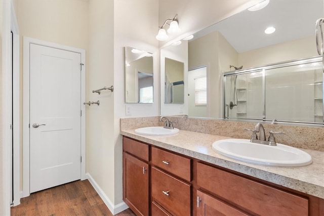 bathroom with vanity, hardwood / wood-style flooring, and walk in shower