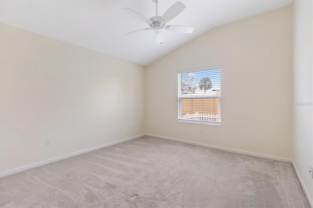 unfurnished room featuring lofted ceiling, light carpet, and ceiling fan