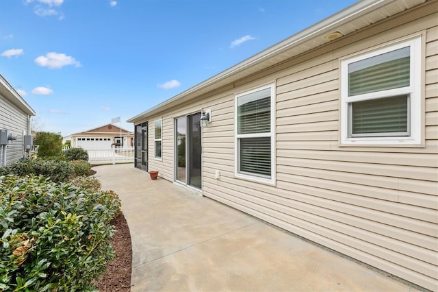 view of side of home with a garage and a patio area