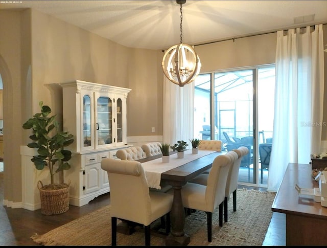 dining room featuring dark hardwood / wood-style floors and a chandelier