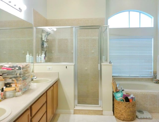 bathroom with vanity, shower with separate bathtub, and tile patterned flooring