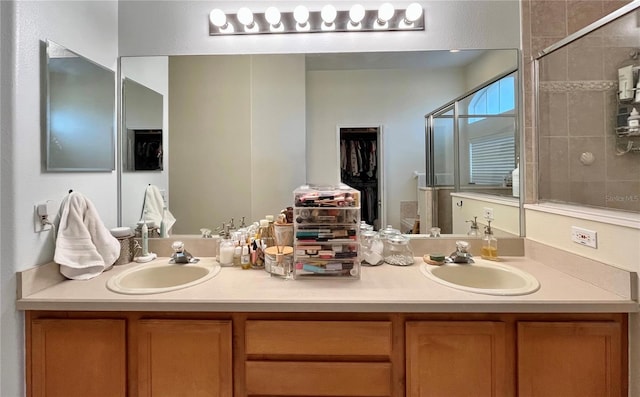 bathroom with vanity and a shower with shower door