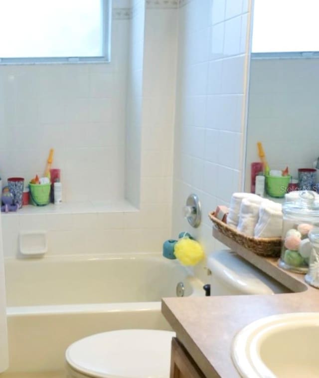 full bathroom featuring vanity, tub / shower combination, and toilet