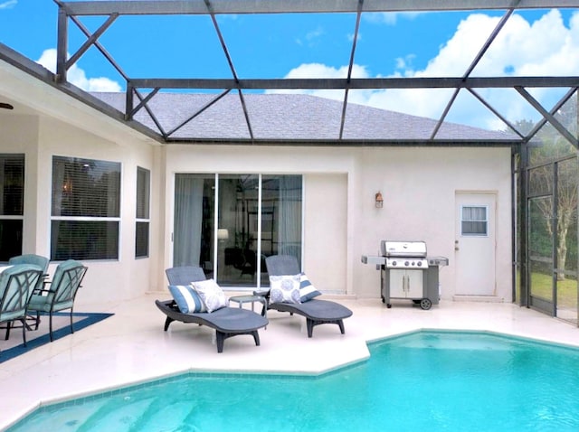 view of pool featuring a patio, area for grilling, and glass enclosure