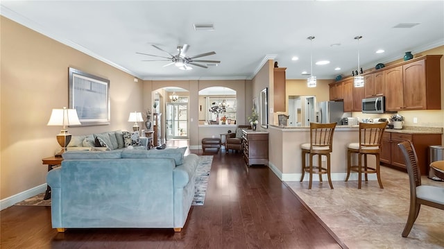 living room with ceiling fan, dark hardwood / wood-style flooring, and ornamental molding