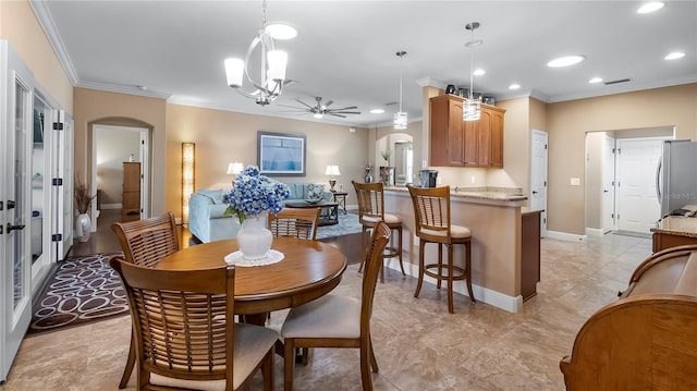 dining space featuring crown molding and ceiling fan