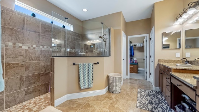 bathroom featuring vanity and a tile shower