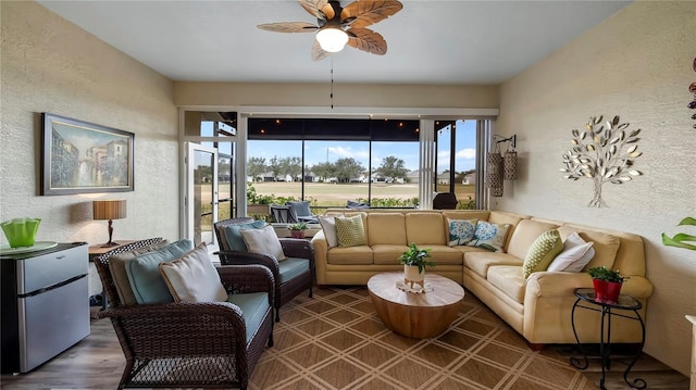 living room featuring dark wood-type flooring and ceiling fan