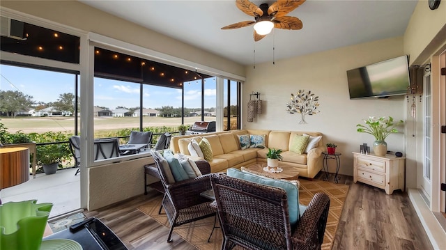 sunroom / solarium featuring ceiling fan