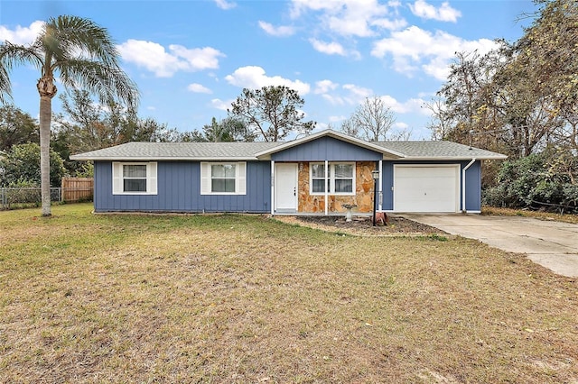 ranch-style home with a garage and a front lawn