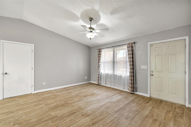 interior space with ceiling fan, a textured ceiling, light wood-type flooring, and vaulted ceiling