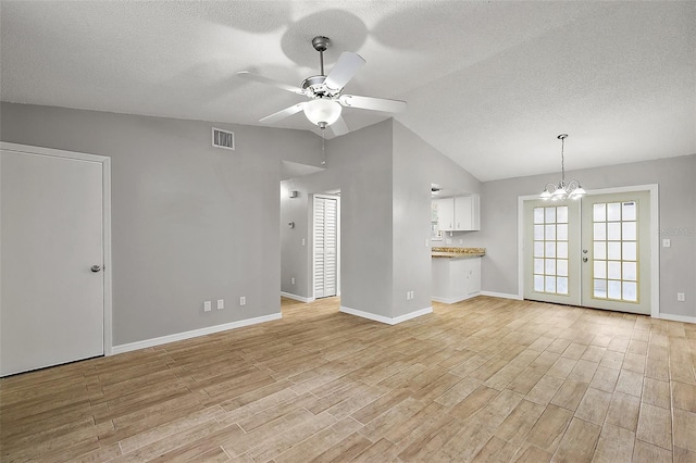 unfurnished living room featuring light hardwood / wood-style floors, a wealth of natural light, and vaulted ceiling