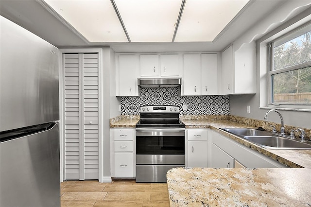 kitchen featuring appliances with stainless steel finishes, white cabinetry, sink, ventilation hood, and light wood-type flooring