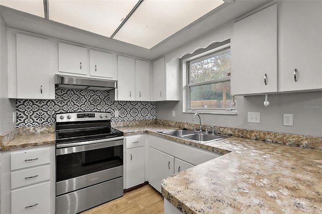 kitchen with extractor fan, white cabinetry, stainless steel range with electric cooktop, and sink