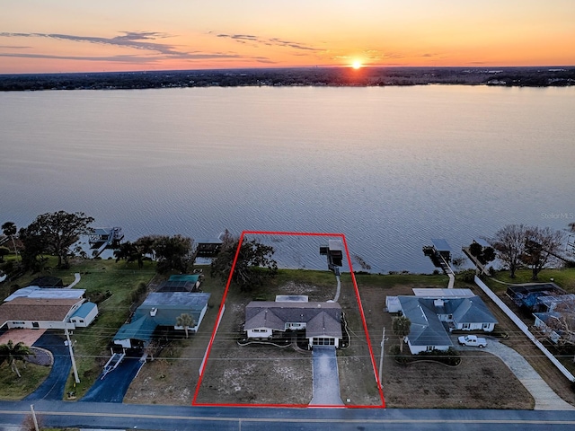 aerial view at dusk with a water view