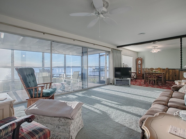 living room with ceiling fan and carpet flooring