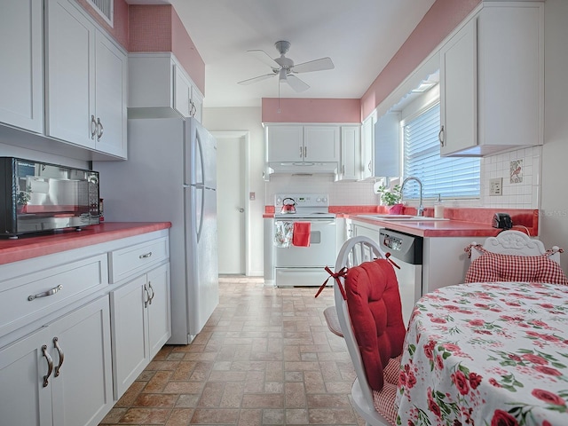 kitchen featuring tasteful backsplash, white cabinetry, sink, ceiling fan, and white appliances