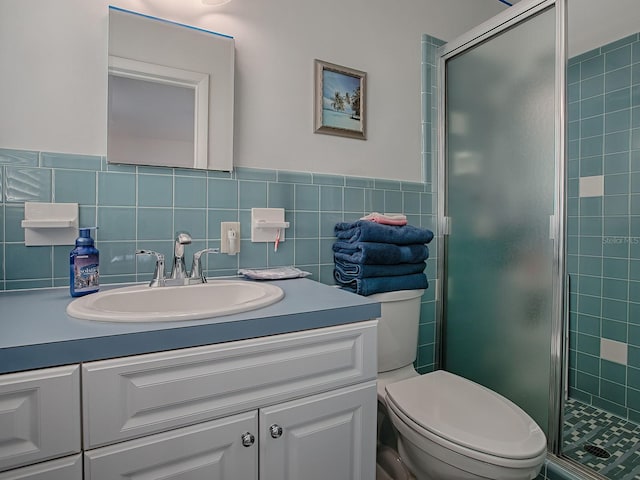 bathroom featuring tile walls, vanity, toilet, and walk in shower