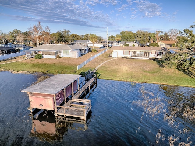 view of dock featuring a water view and a yard