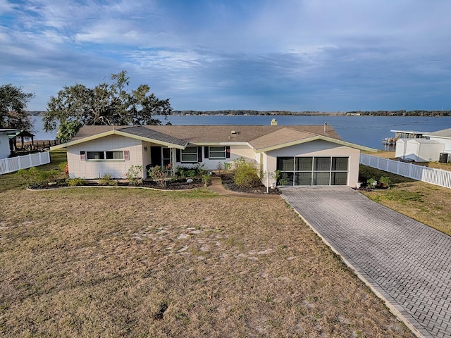 ranch-style house with a water view and a front yard