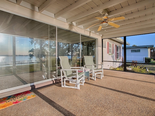 sunroom with wood ceiling, beam ceiling, and ceiling fan