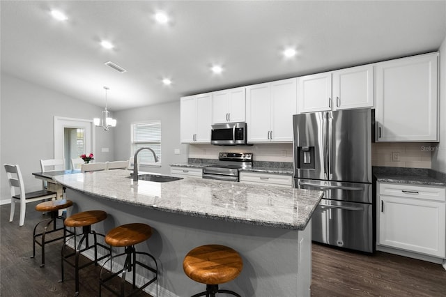 kitchen featuring appliances with stainless steel finishes, sink, and a kitchen island with sink