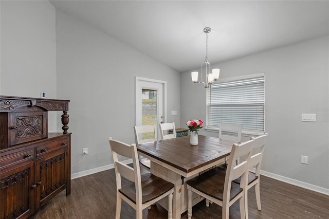 dining room featuring vaulted ceiling, dark hardwood / wood-style floors, and a chandelier