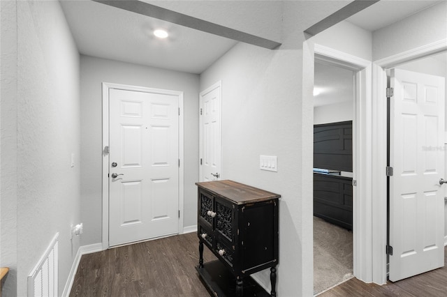 hallway with dark hardwood / wood-style flooring