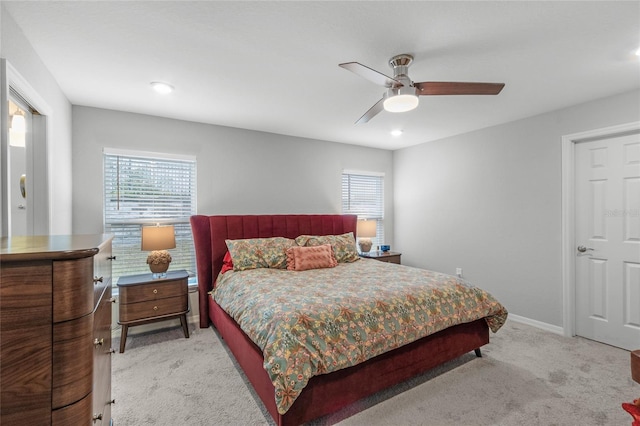 bedroom with ceiling fan and light carpet