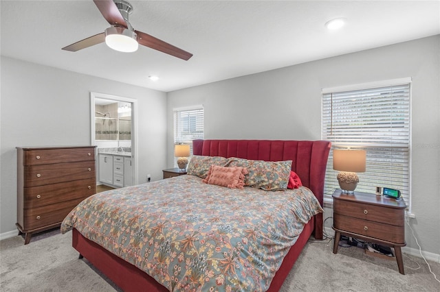 carpeted bedroom featuring ceiling fan and connected bathroom