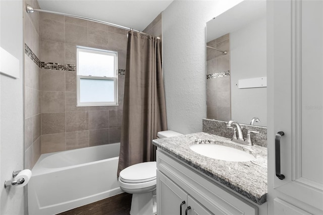 full bathroom featuring vanity, wood-type flooring, shower / bath combo with shower curtain, and toilet