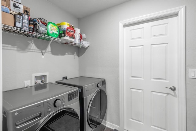 clothes washing area featuring hardwood / wood-style flooring and washer and clothes dryer