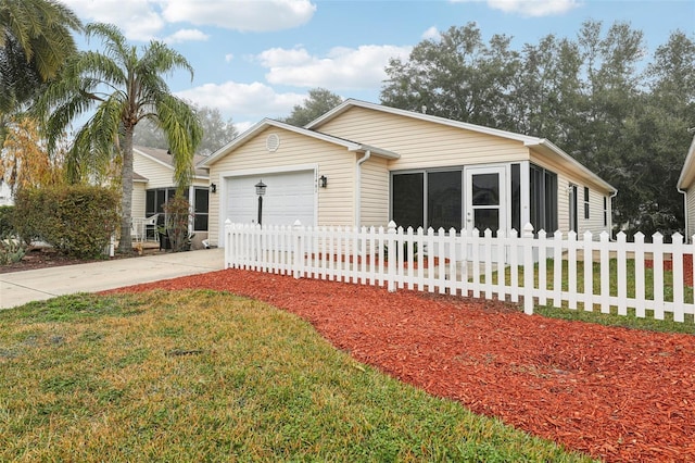 17461 SE 93rd Retford Ter, The Villages, FL 32162 - view of front of property with an attached garage, a sunroom, driveway, and fence private yard
