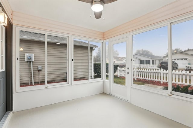 sunroom / solarium featuring a wealth of natural light and ceiling fan