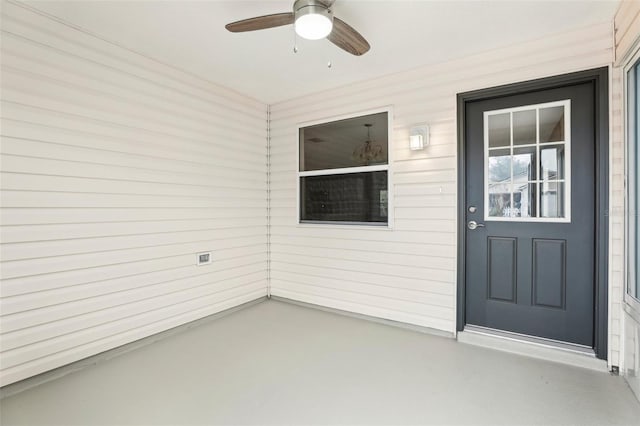 doorway to property featuring ceiling fan