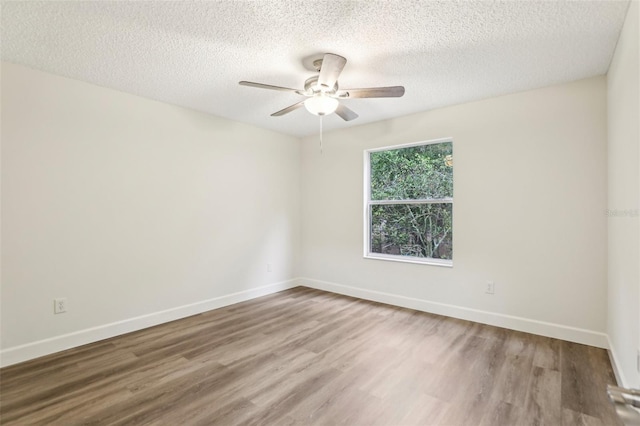 unfurnished room with ceiling fan, hardwood / wood-style floors, and a textured ceiling