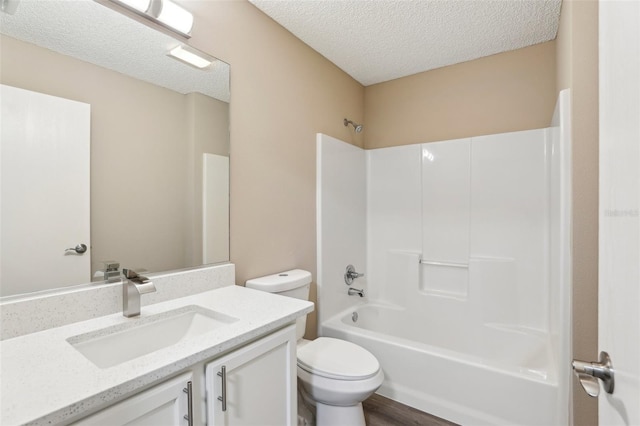 full bathroom with vanity, toilet, shower / bathing tub combination, and a textured ceiling