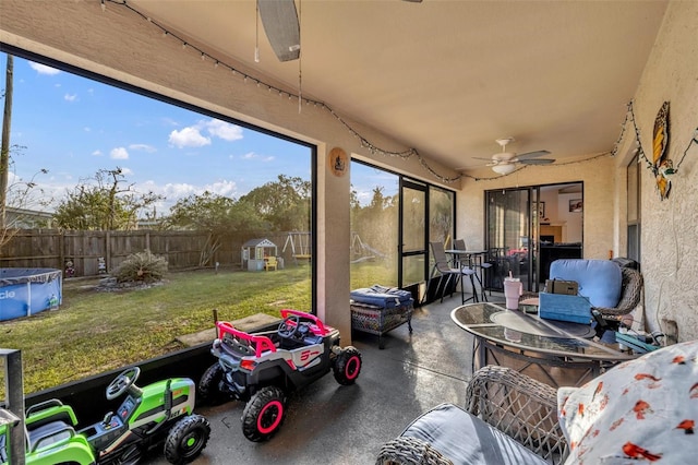 sunroom / solarium featuring ceiling fan