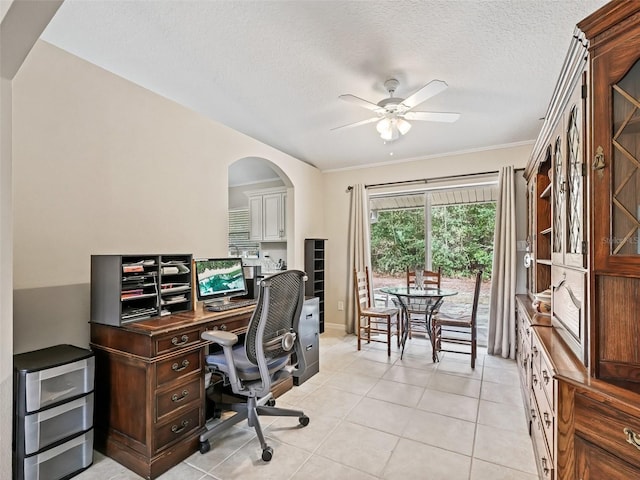 office area with light tile patterned flooring, ceiling fan, crown molding, and a textured ceiling