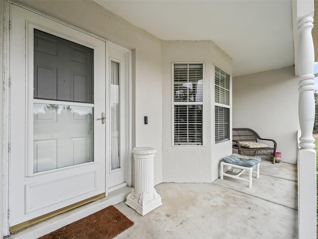 view of exterior entry with covered porch