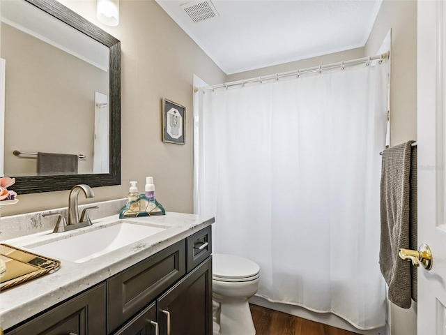 bathroom featuring wood-type flooring, vanity, and toilet