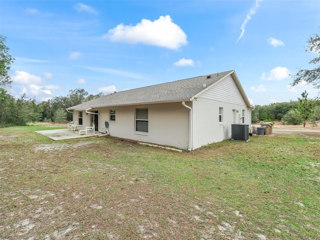 rear view of house featuring a yard, a patio area, and central AC