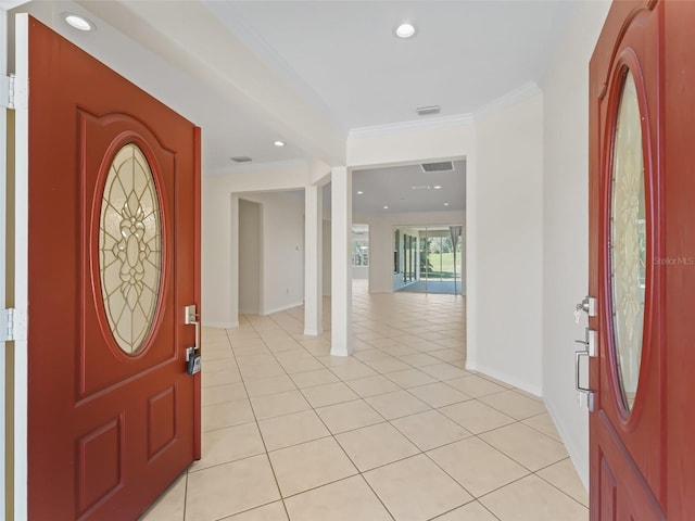 tiled foyer with ornamental molding